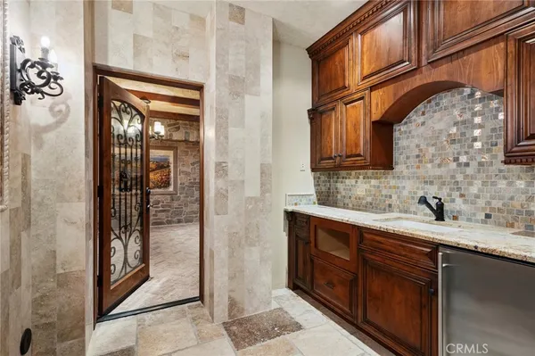 a bathroom with a granite countertop sink a mirror and shower