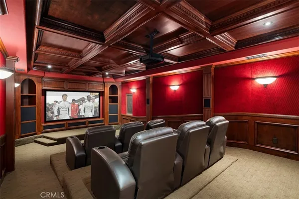 a room with furniture projector and screen