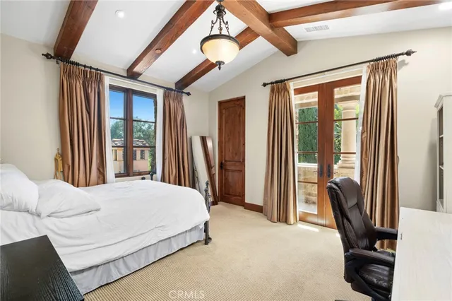 a bedroom with a bed closet and a large window