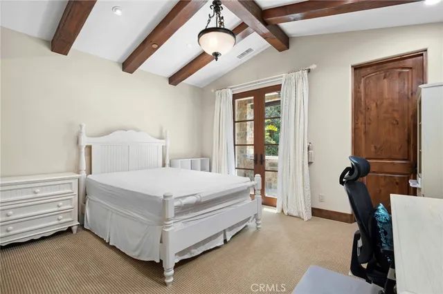 a bed room with a bed and a chair