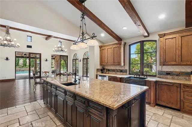 a kitchen with sink a counter top space and living room