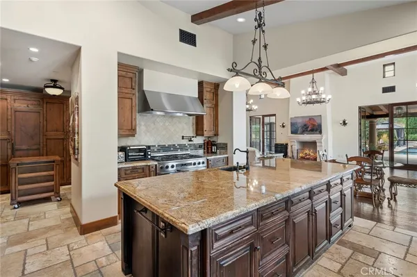 a kitchen with stainless steel appliances granite countertop a sink a counter top space cabinets and counter space