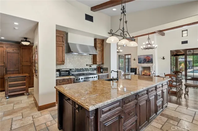 a kitchen with stainless steel appliances granite countertop a sink a counter top space cabinets and counter space