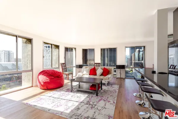 a bedroom with furniture and a large window