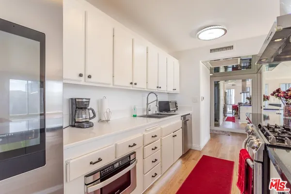 a kitchen with stove and cabinets