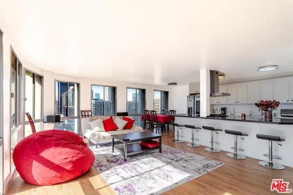 a kitchen with stainless steel appliances kitchen island granite countertop a dining table chairs and granite counter tops