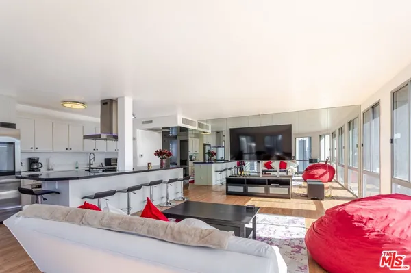 a spacious bedroom with a bed a glass walk in closet and a window