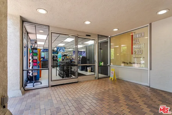 a view of an empty room with furniture and a window