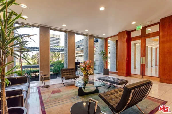 a living room with furniture and large windows