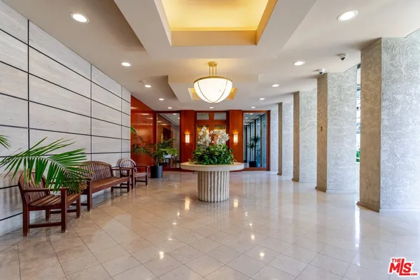 a living room with furniture and floor to ceiling window