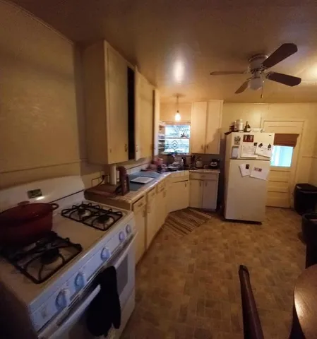 a kitchen with sink stove and refrigerator