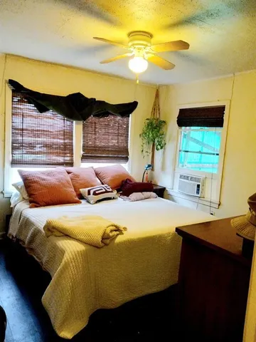 a bedroom with a bed and a night stand