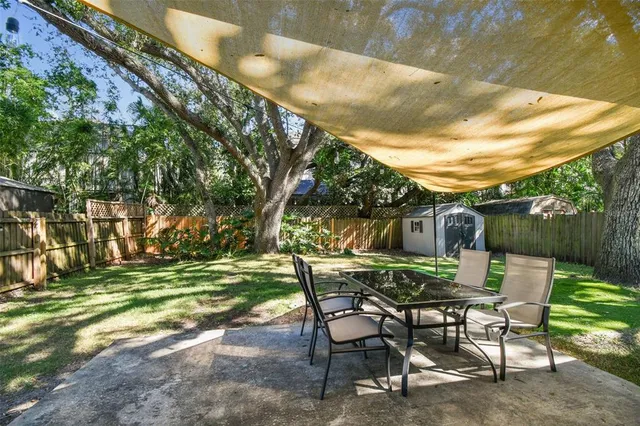a view of a backyard with a table and chairs