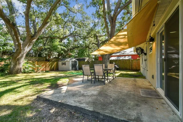 a view of a park with bench and trees