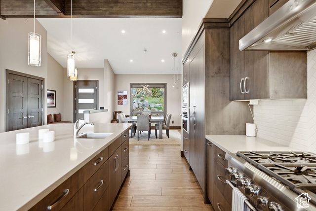 1130 Pace Road Park City, UT 84098 - Photo 25 of 73 Kitchen featuring wood-finish flooring, light-toned countertops, and dark wood-finish cabinetry