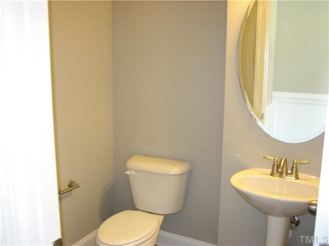 2204 Lower Lake Road Wake Forest, NC 27587 - Photo 6 of 24 Powder Room off Breakfast, pedestal sink, Oval mirror and hardwoods