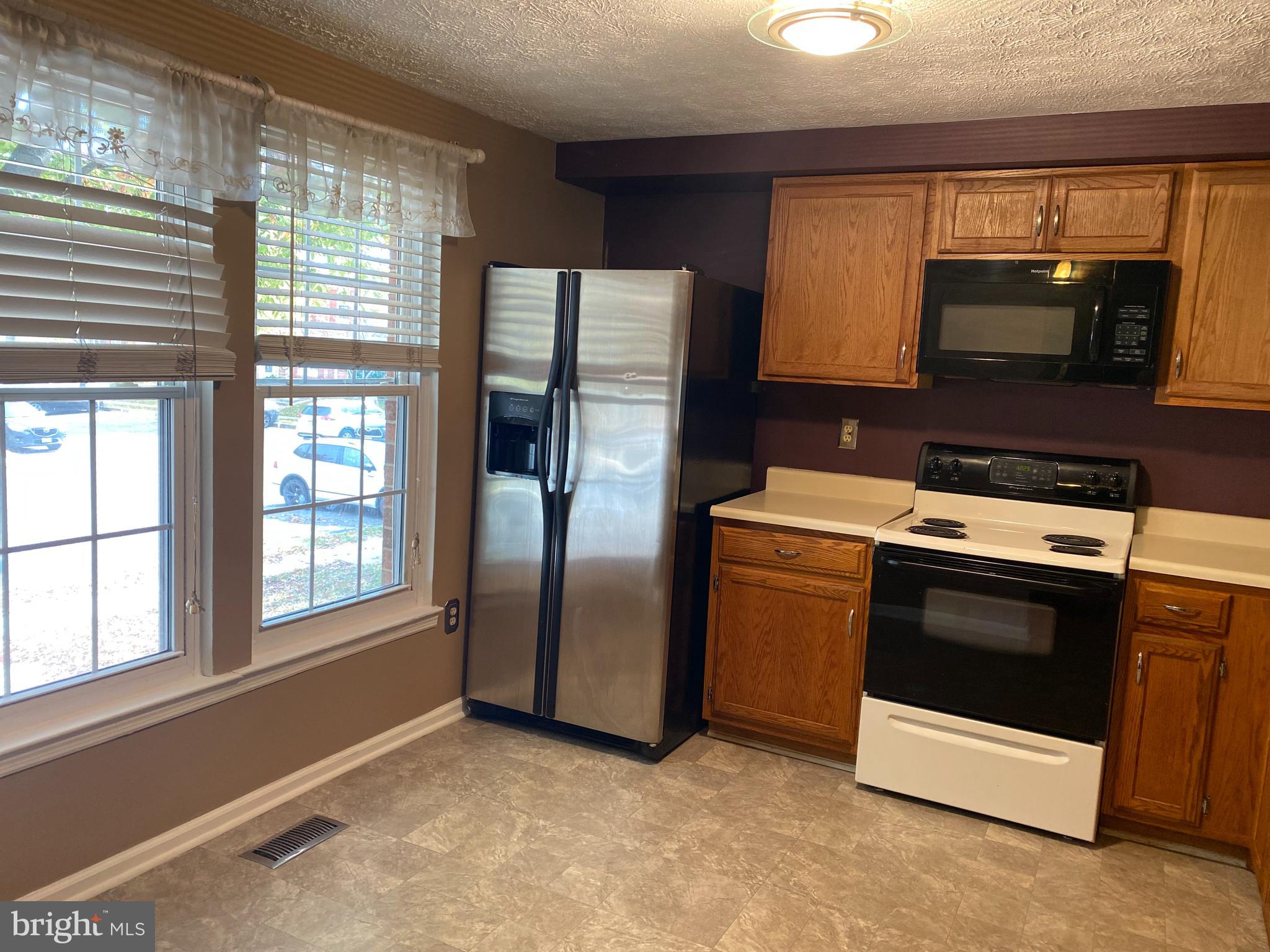 35 Cavan Green Baltimore, MD 21236 - Photo 3 of 16 a kitchen with stainless steel appliances granite countertop a stove a microwave and a refrigerator