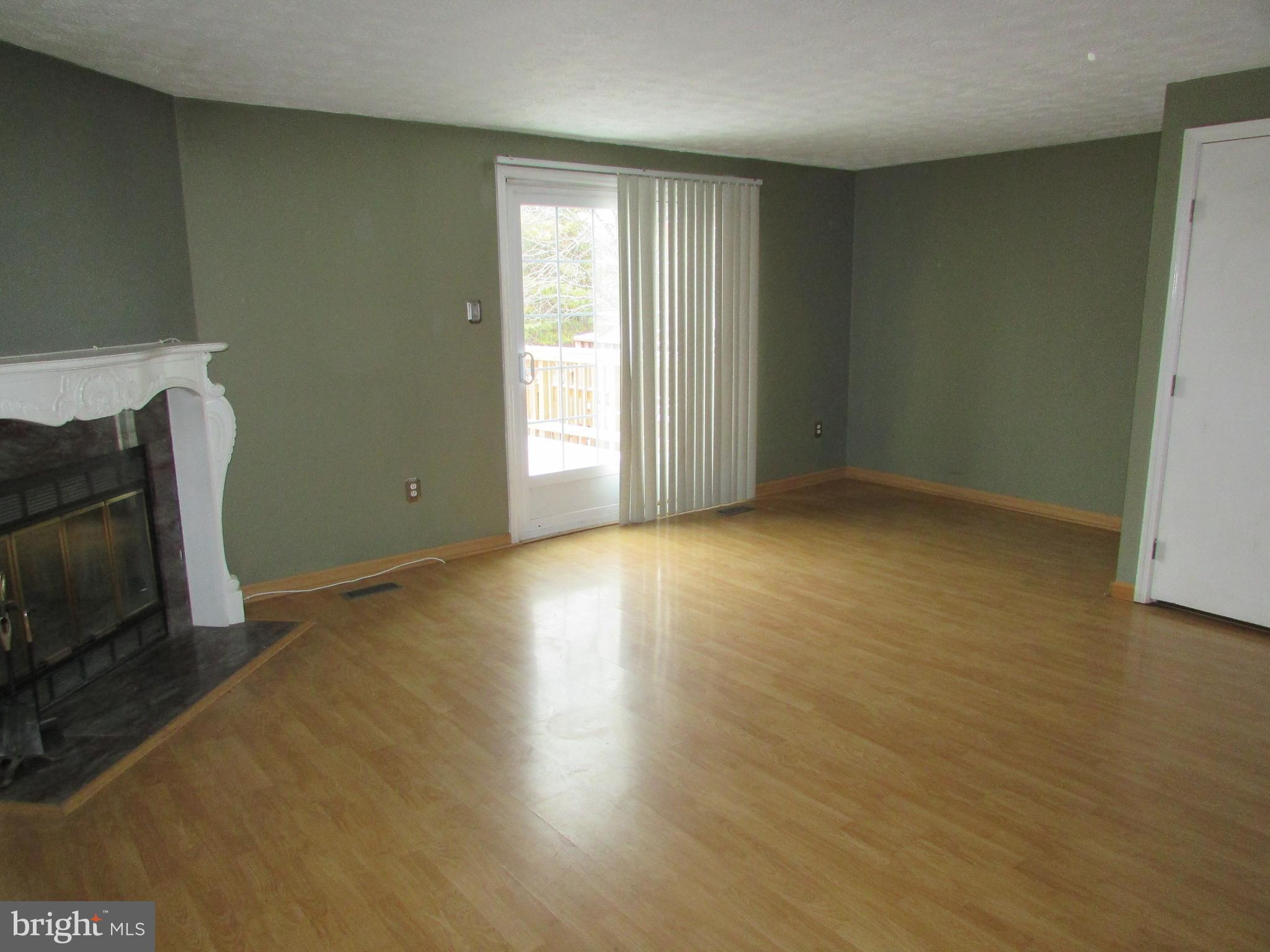 35 Cavan Green Baltimore, MD 21236 - Photo 5 of 16 an empty room with wooden floor and a window