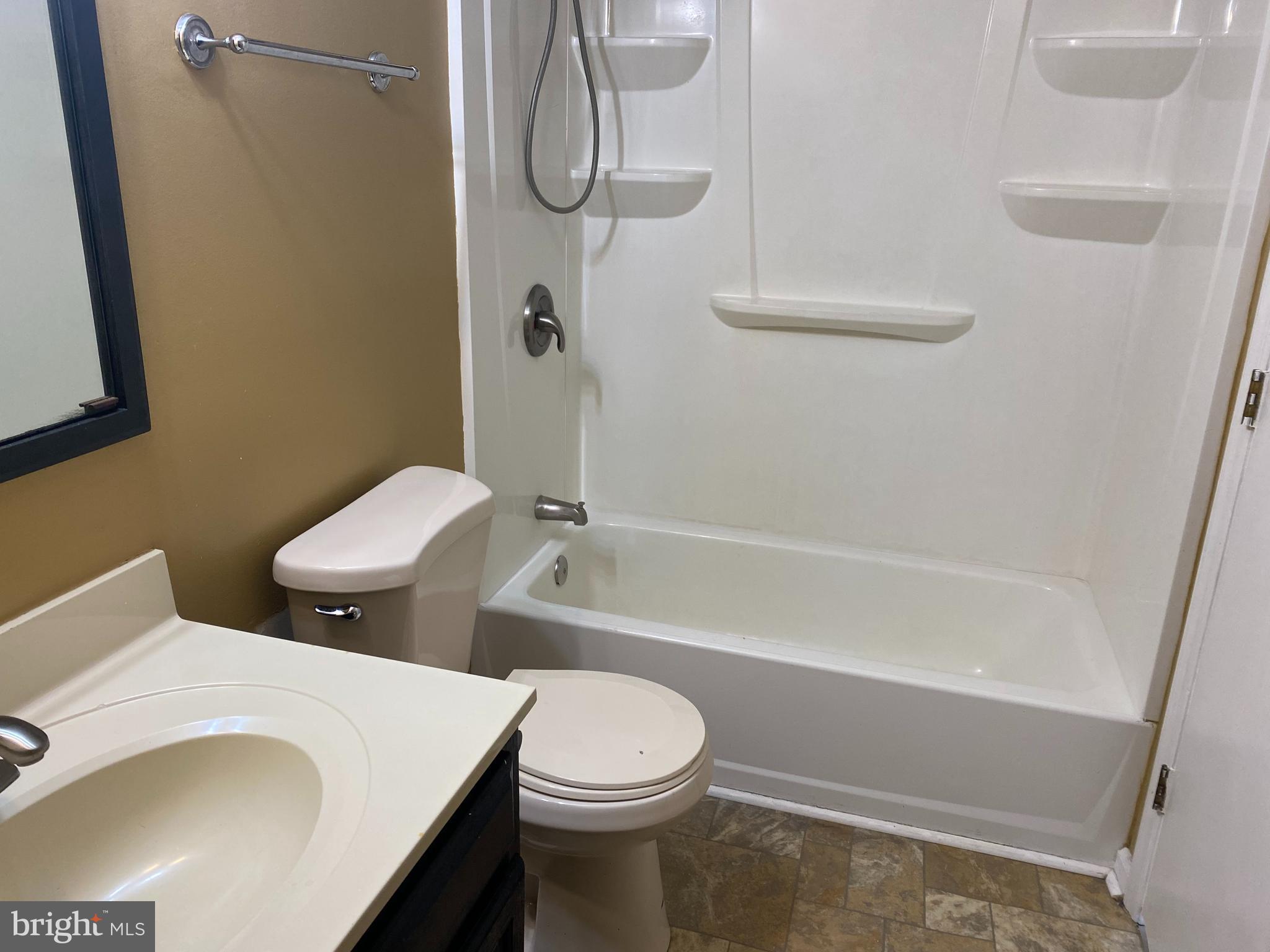 35 Cavan Green Baltimore, MD 21236 - Photo 8 of 16 a white toilet sitting next to a bath tub and a shower