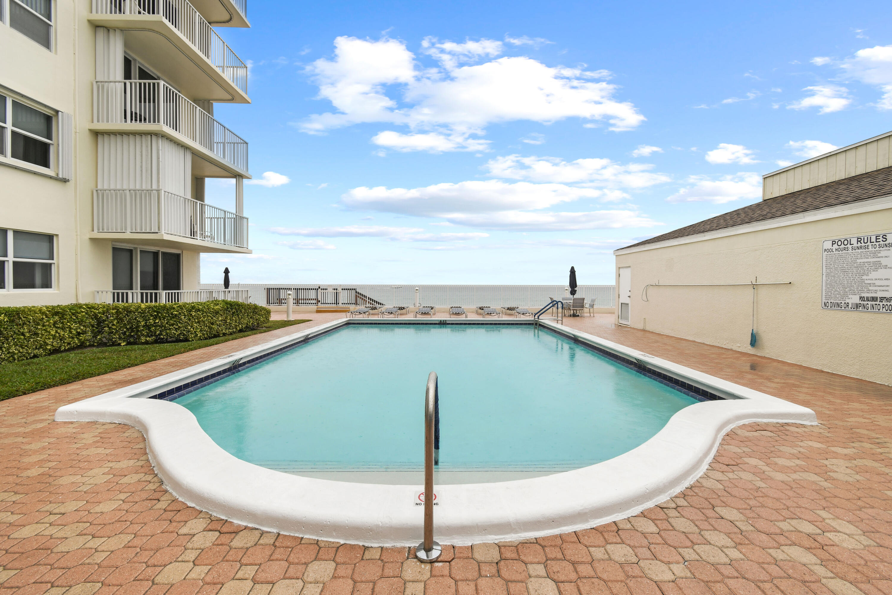 3540 South Ocean Boulevard, Unit 611 South Palm Beach, FL 33480 - Photo 17 of 27 a view of a swimming pool with a yard