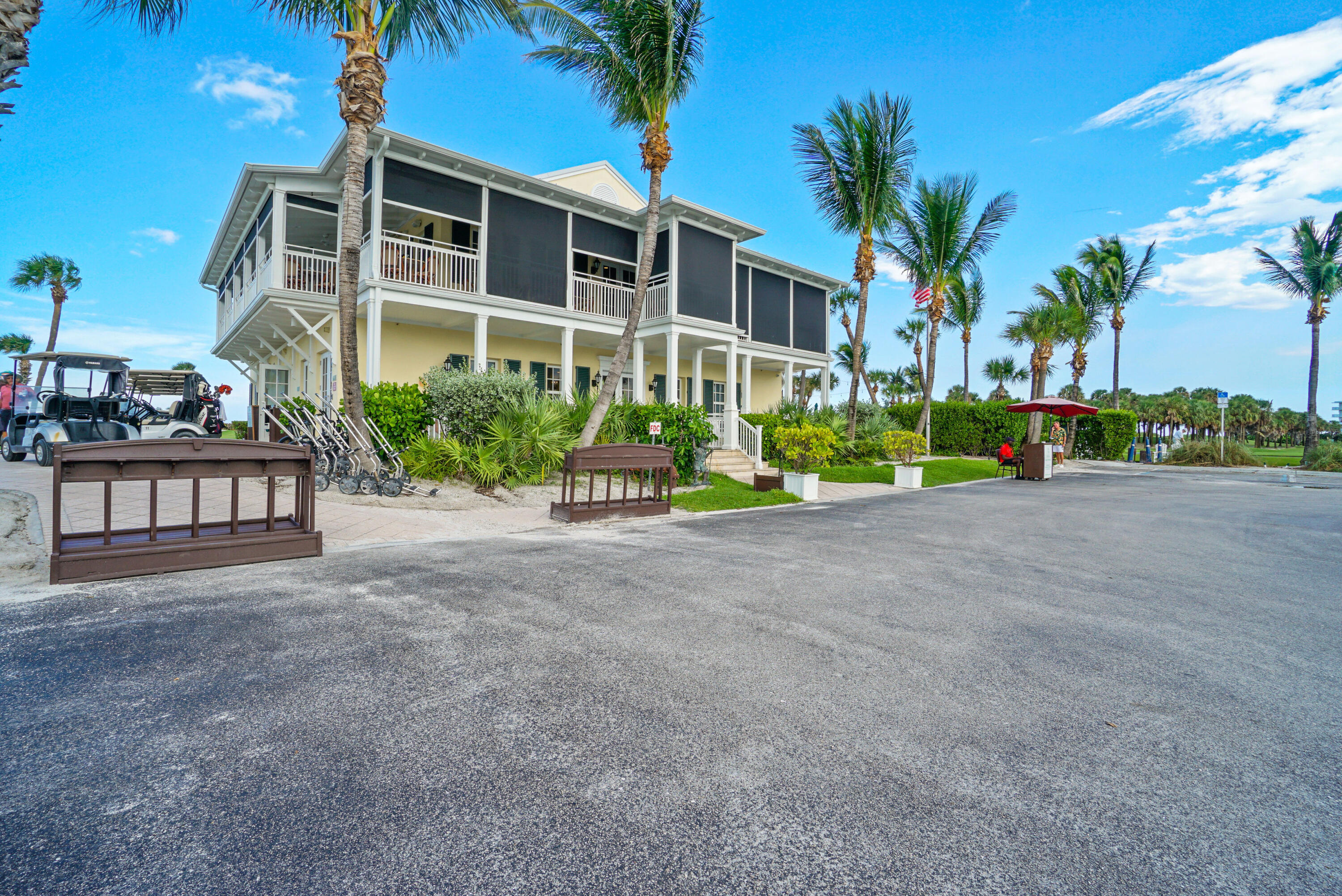 3540 South Ocean Boulevard, Unit 611 South Palm Beach, FL 33480 - Photo 21 of 27 a front view of a house with a yard and potted plants