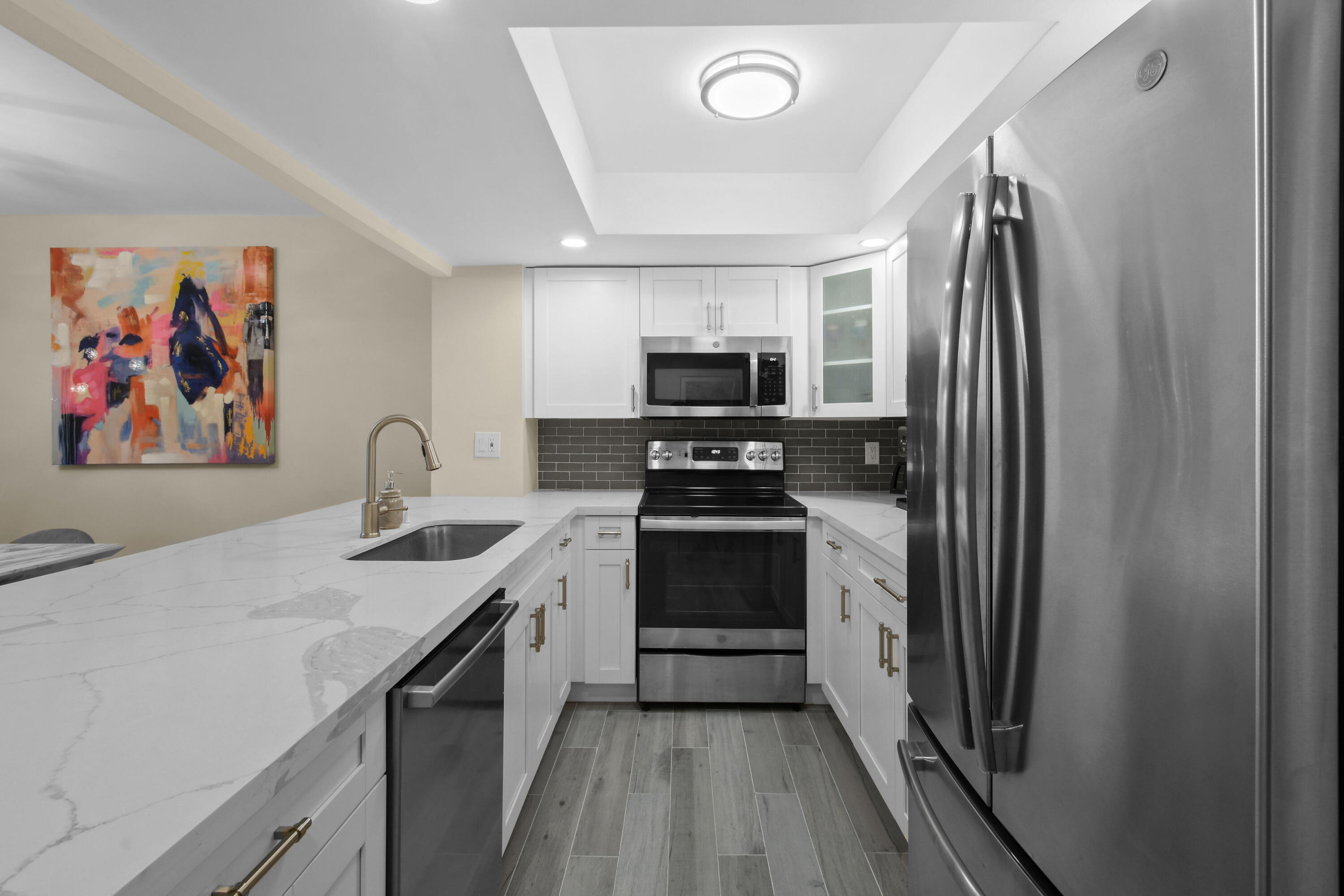 3540 South Ocean Boulevard, Unit 611 South Palm Beach, FL 33480 - Photo 7 of 27 a kitchen with a sink stainless steel appliances and cabinets