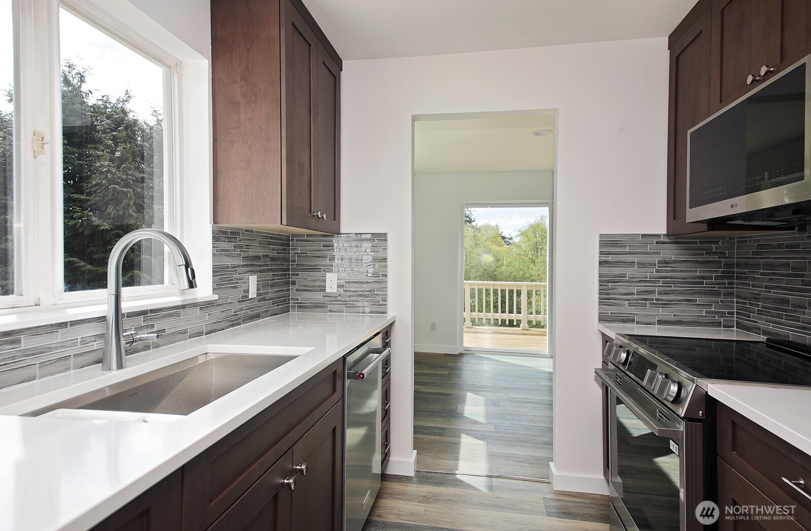 3760 Periwinkle Road Clinton, WA 98236 - Photo 13 of 34 a kitchen with a sink and a stove top oven