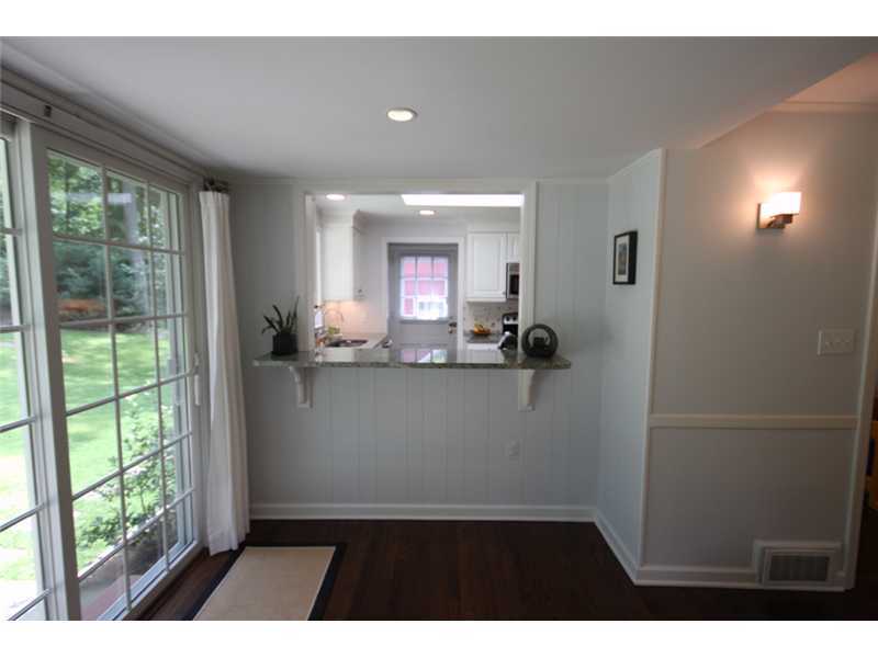 6 Little Brook Road Rowayton, CT 06853 - Photo 7 of 23 a living room with a large window and chandelier