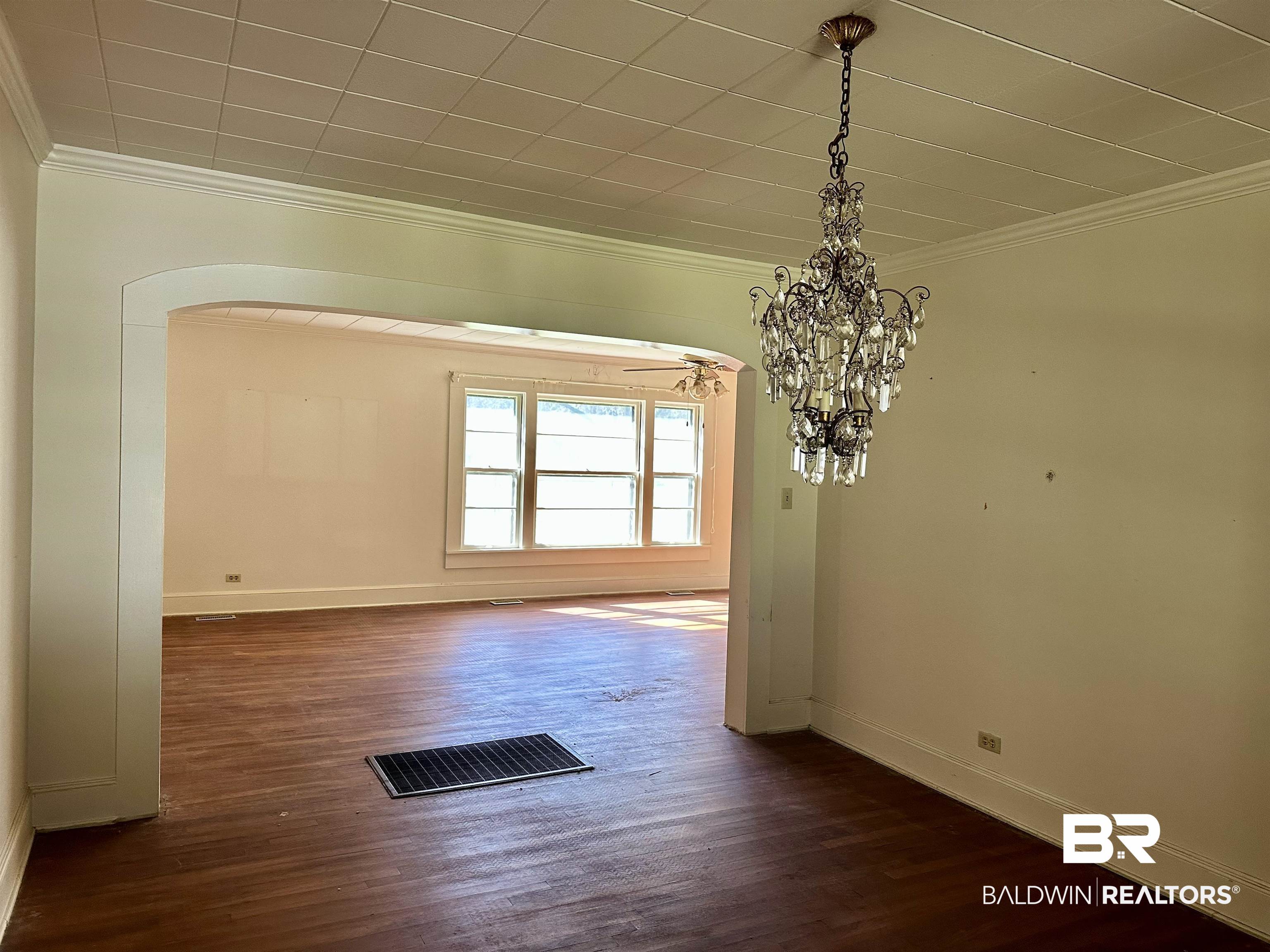 3556 Damascus Road Brewton, AL 36426 - Photo 6 of 17 Unfurnished dining area with a notable chandelier, visible vents, dark wood finished floors, and ornamental molding
