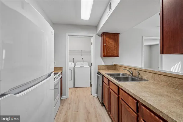 a view of a kitchen from the hallway