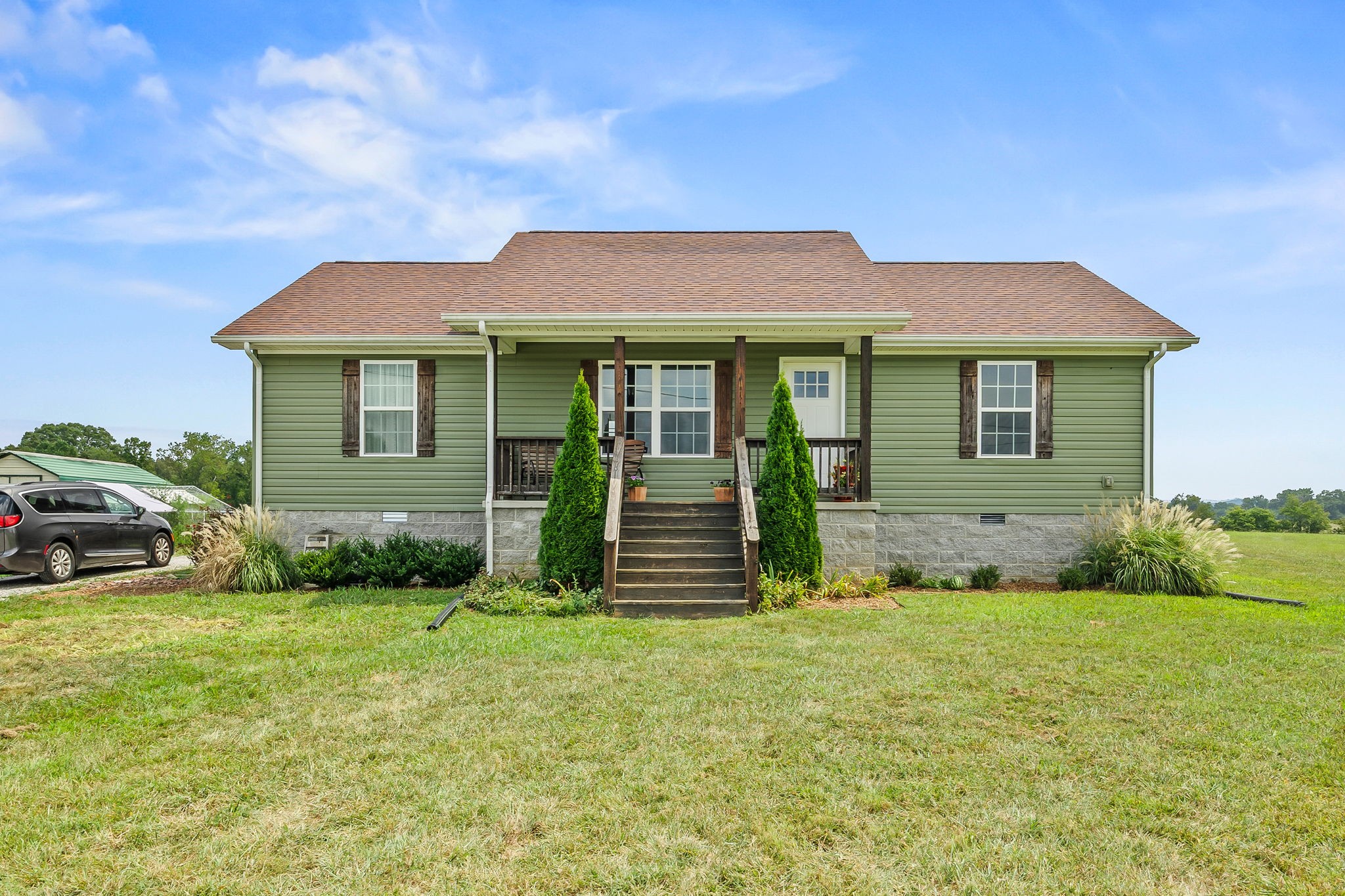 a front view of a house with garden