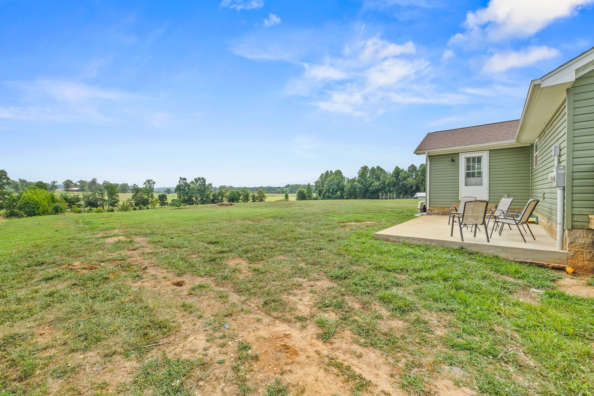 13723 Old Kentucky Road Walling, TN 38587 - Photo 20 of 34 a view of a patio with table and chairs and potted plants