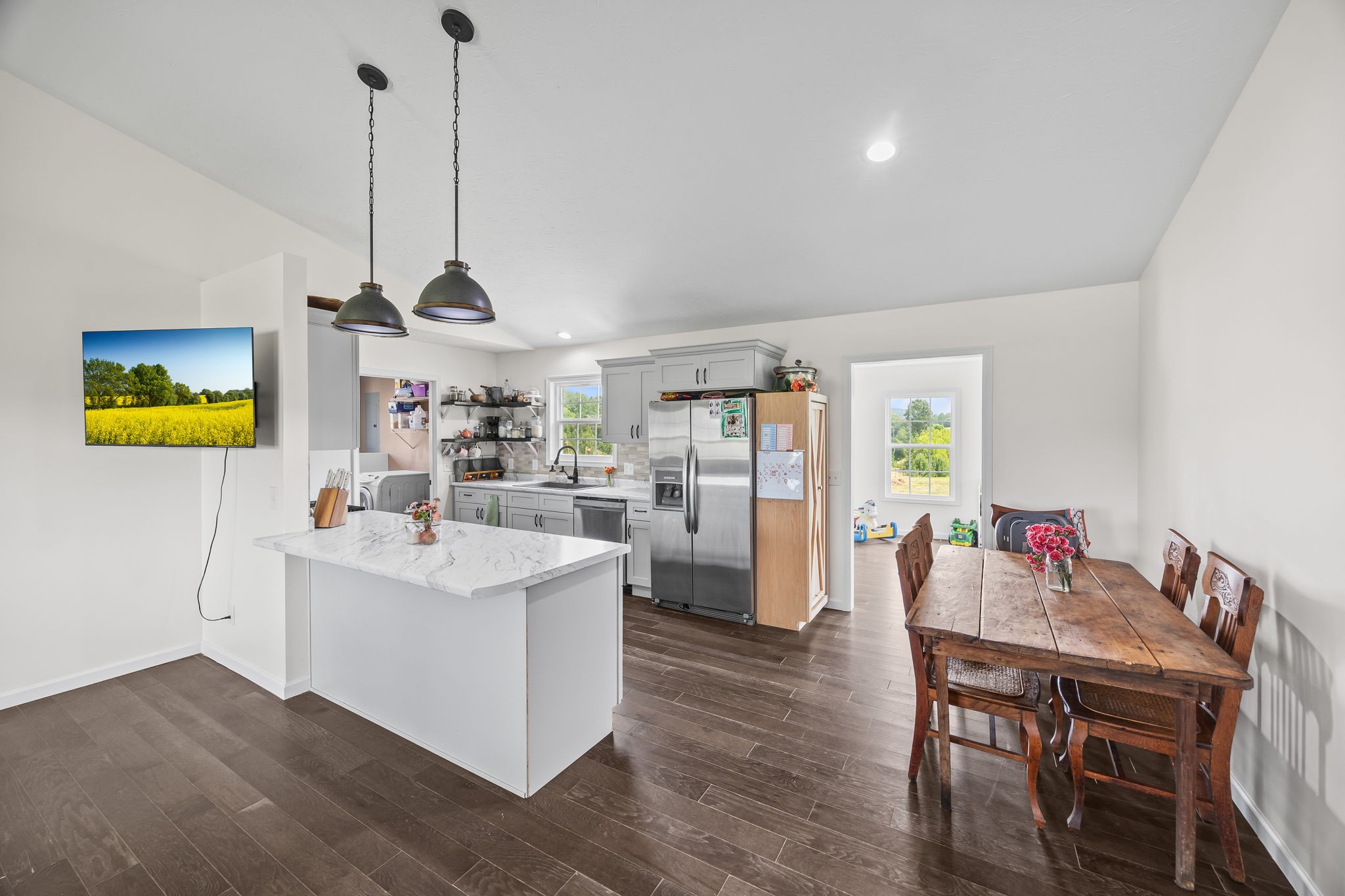 13723 Old Kentucky Road Walling, TN 38587 - Photo 5 of 34 a view of kitchen island with stainless steel appliances sink microwave and wooden floor