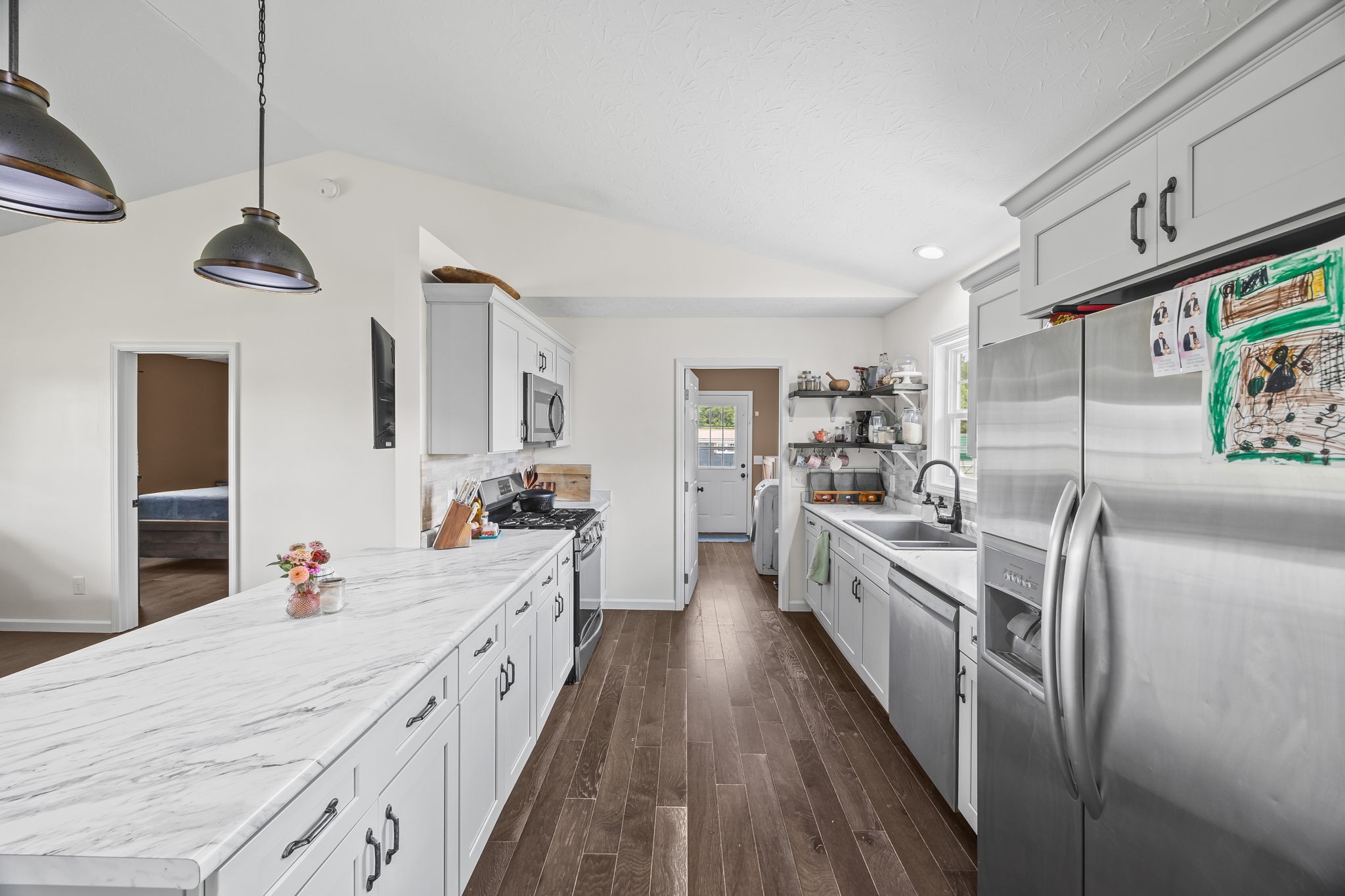 13723 Old Kentucky Road Walling, TN 38587 - Photo 6 of 34 a large kitchen with stainless steel appliances lots of counter space and wooden floor