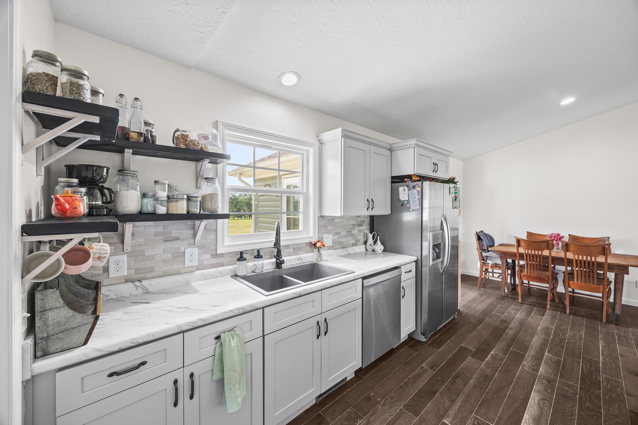 13723 Old Kentucky Road Walling, TN 38587 - Photo 8 of 34 a kitchen with stainless steel appliances granite countertop a sink and wooden floor