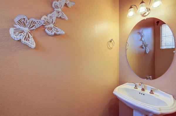 a bathroom with a sink and mirror