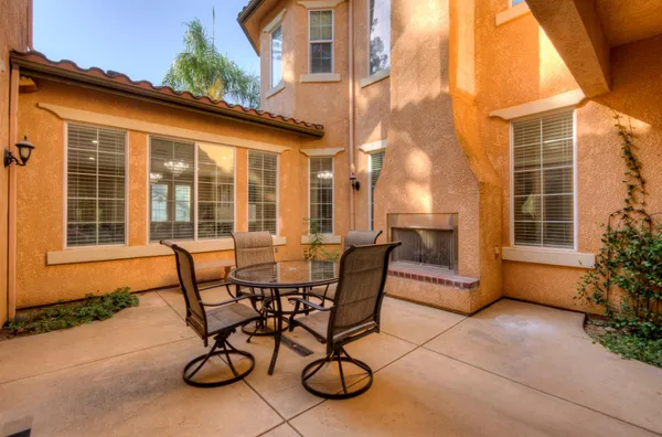 a view of a patio with table and chairs and potted plants