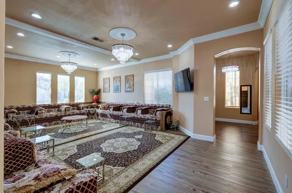 a living room with furniture and wooden floor