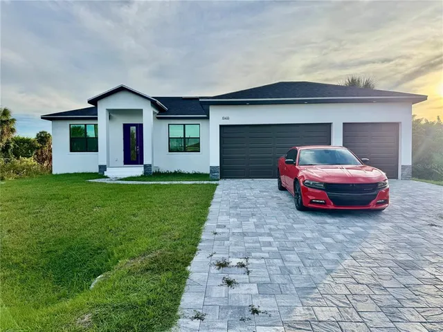 a car parked in front of white house