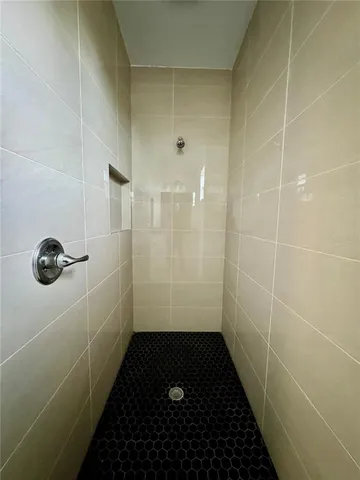 a bathroom with a granite countertop sink and a toilet