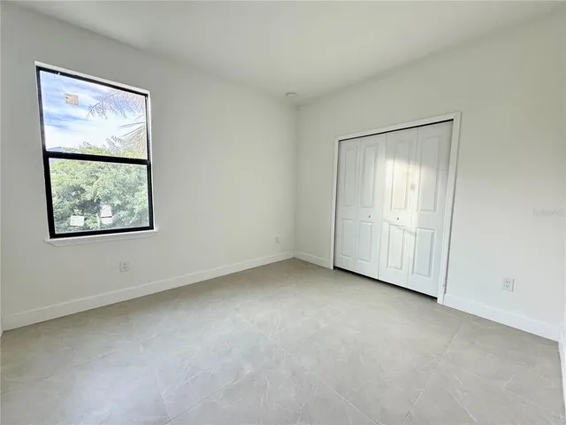 an empty room with closet and mirrors