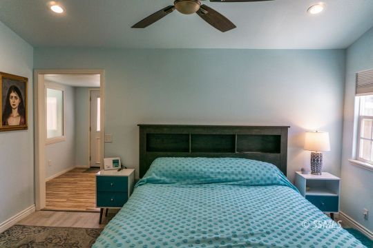 718 La Paloma Street Ridgecrest, CA 93555 - Photo 34 of 50 a bedroom with a bed and wooden floor