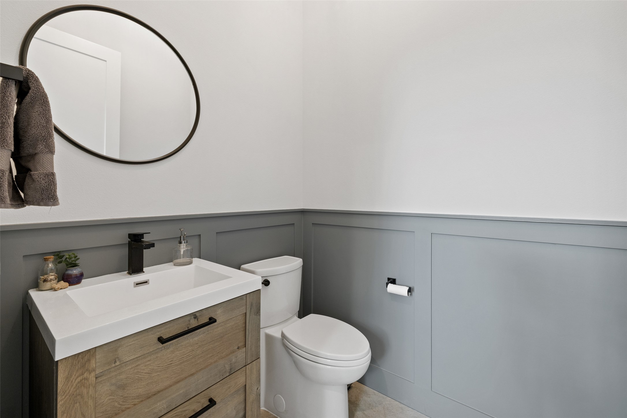 1504 Ruth Avenue, Unit 3 Austin, TX 78757 - Photo 30 of 39 A refined bathroom features wainscoting details and a vanity with sleek, modern fixtures.