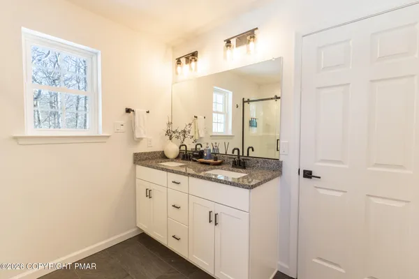 a bathroom with a granite countertop sink a mirror and a