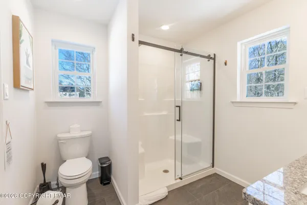 a bathroom with a toilet sink and a shower