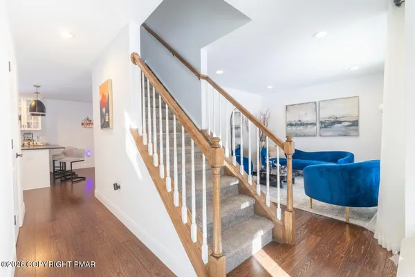 a view of entryway and hall with wooden floor