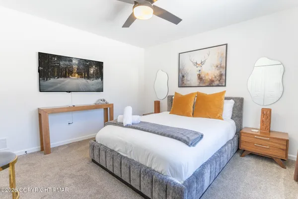 a bedroom with a bed and a wall painting