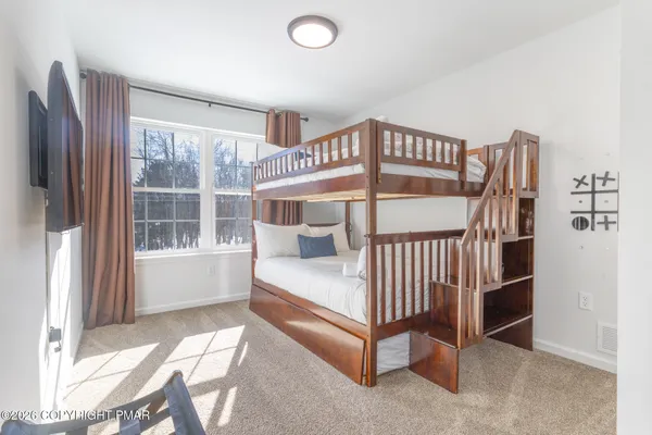 a bedroom with furniture and a window