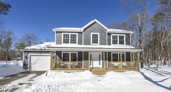 a front view of a house with a yard outdoor seating and utility room