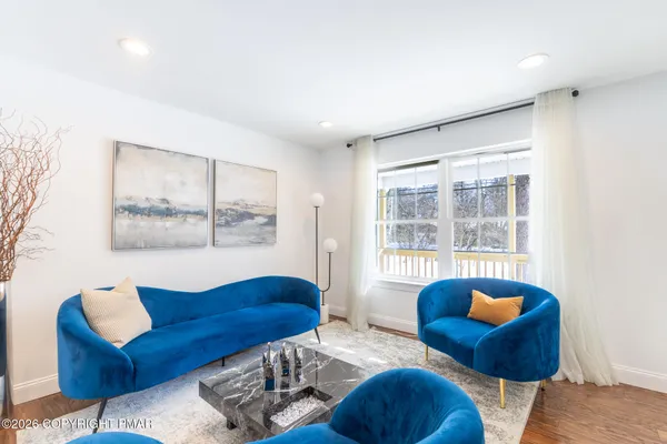 a living room with furniture and a large window